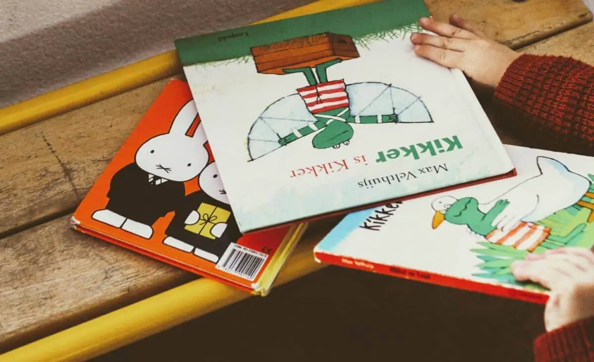 Toddler hands touching books